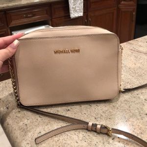 a small, light pink cross body.